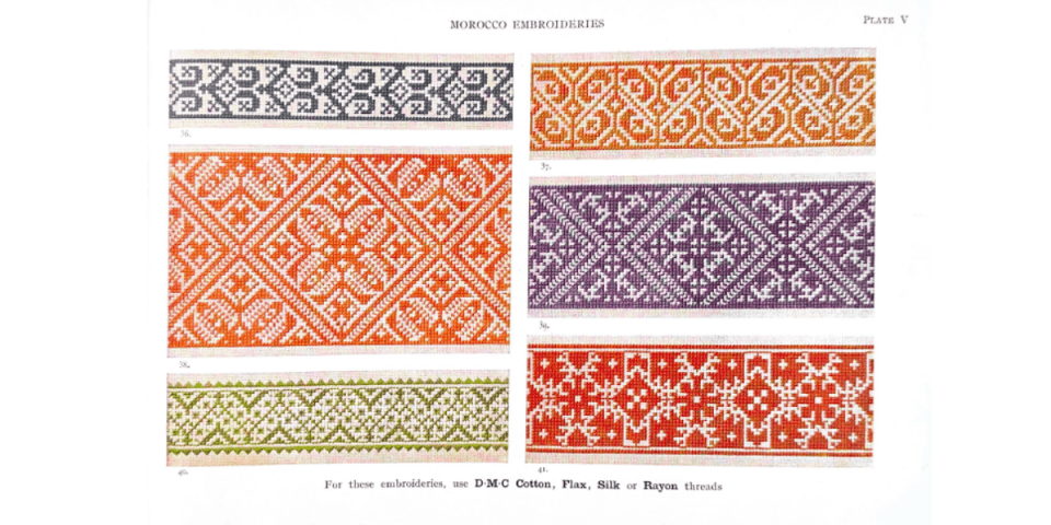 A page from the DMC Library displays several examples of Moroccon embroidery patterns, each in somewhat muted but striking colors. Each pattern is unique, some are floral, others are more geometric, and done in a single color (red, orange, blue, purple, or green) on an off-white background. Above the patterns, the text on the page reads "Morroco Embroideries, Plate V" and below it reads "For these embroideries, use DMC cotton, flax, silk, or rayon threads."