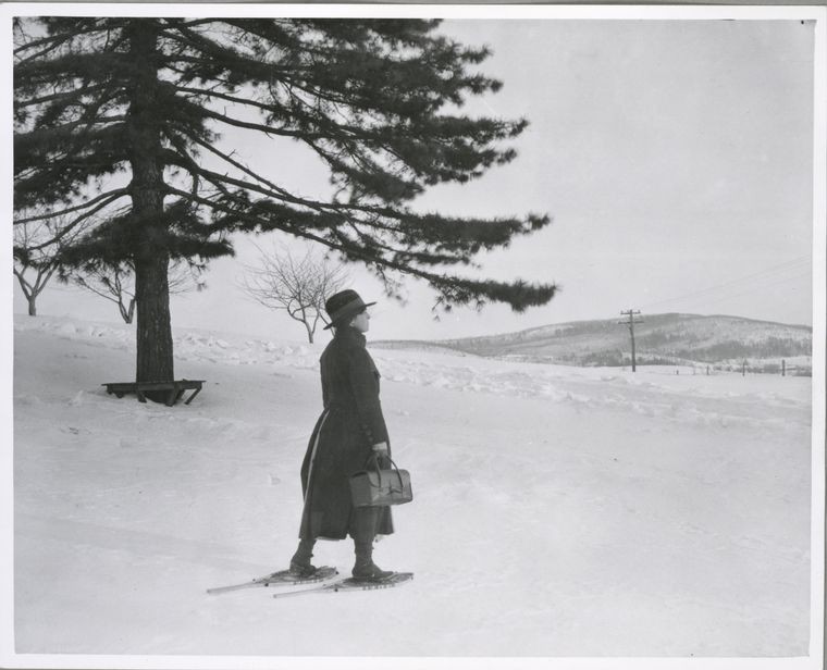 rural health nurse walking in snowshoes through snowy field