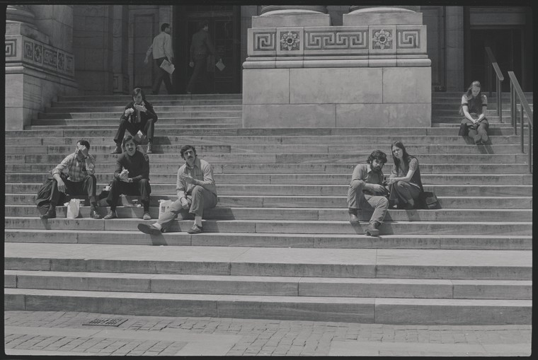 people sitting on steps of Library's main building