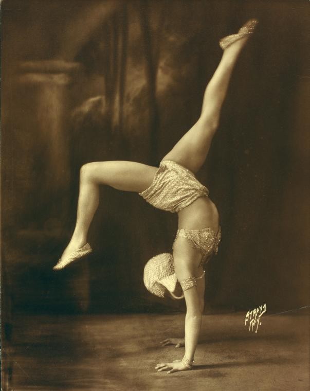 Dancer in handstand wearing rhinestone costume