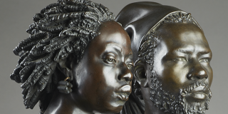 Detail of two bronze sculptures of an African man and woman by Charles Henri Joseph Cordier 