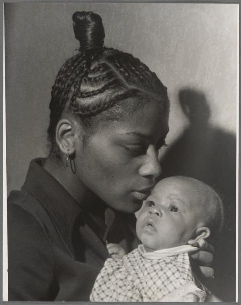 Black and white portrait of a Mother with braided hair holding a young baby