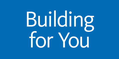 Blue background with white text that reads: Building for You.